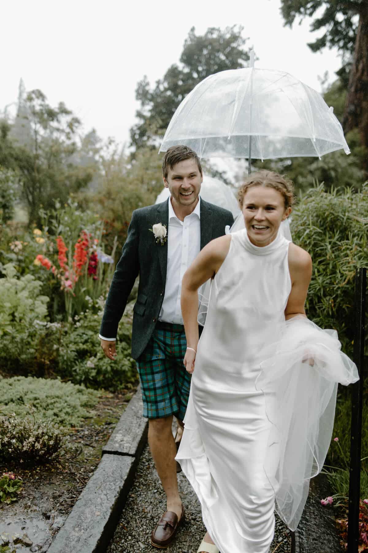 Bride and groom walking through a garden