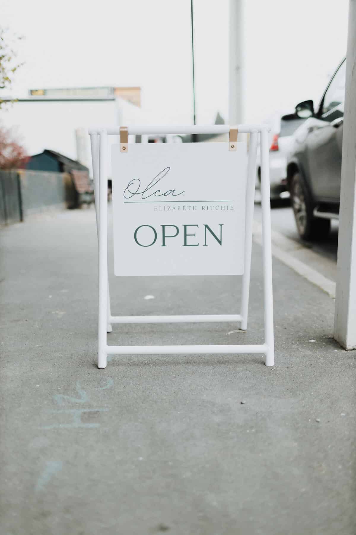 Footpath sign to a design store