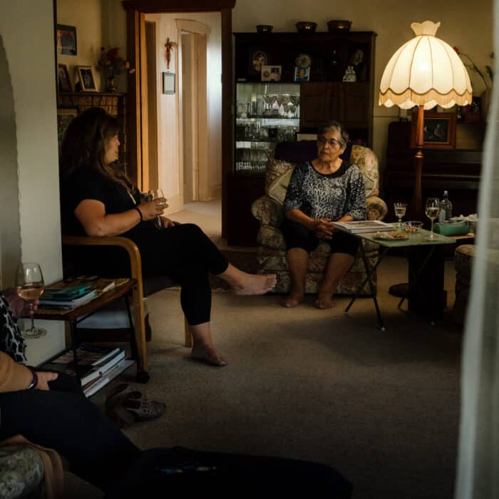 Mairangi and her two daughters sitting in the living room.