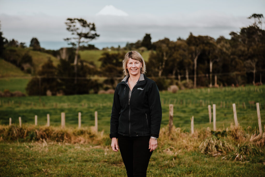 Woman stands in a farm paddock