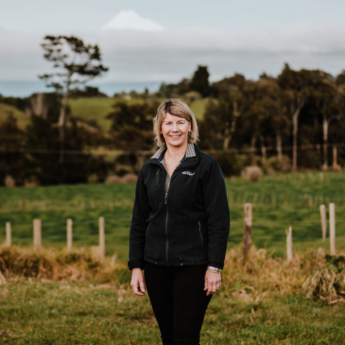 Woman stands in a farm paddock