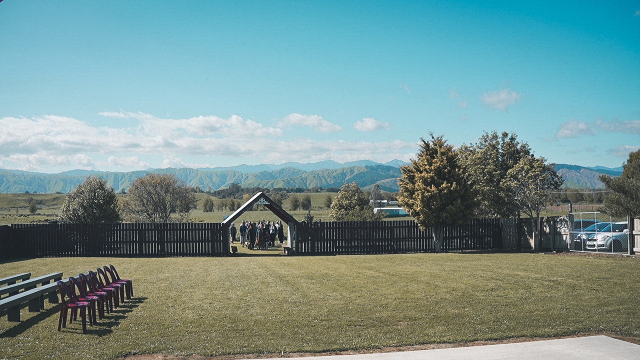 Waiting to enter the main gate of Kererū Marae for the mokopapa.