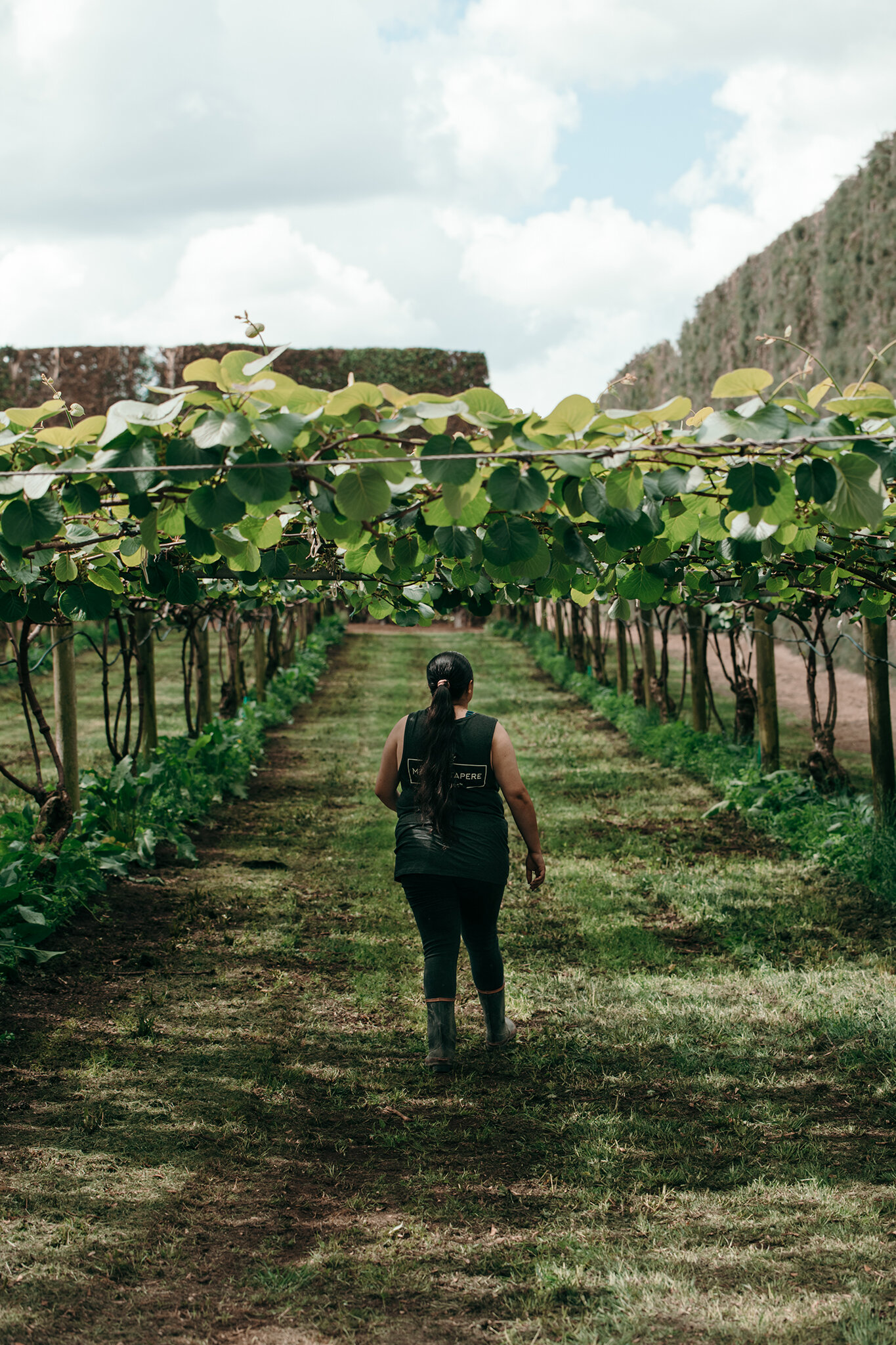 Finnisha walking under berry plants