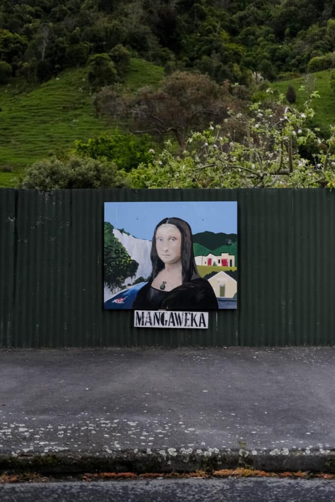 Mona Lisa with a Mangaweka backdrop, painted on a fence