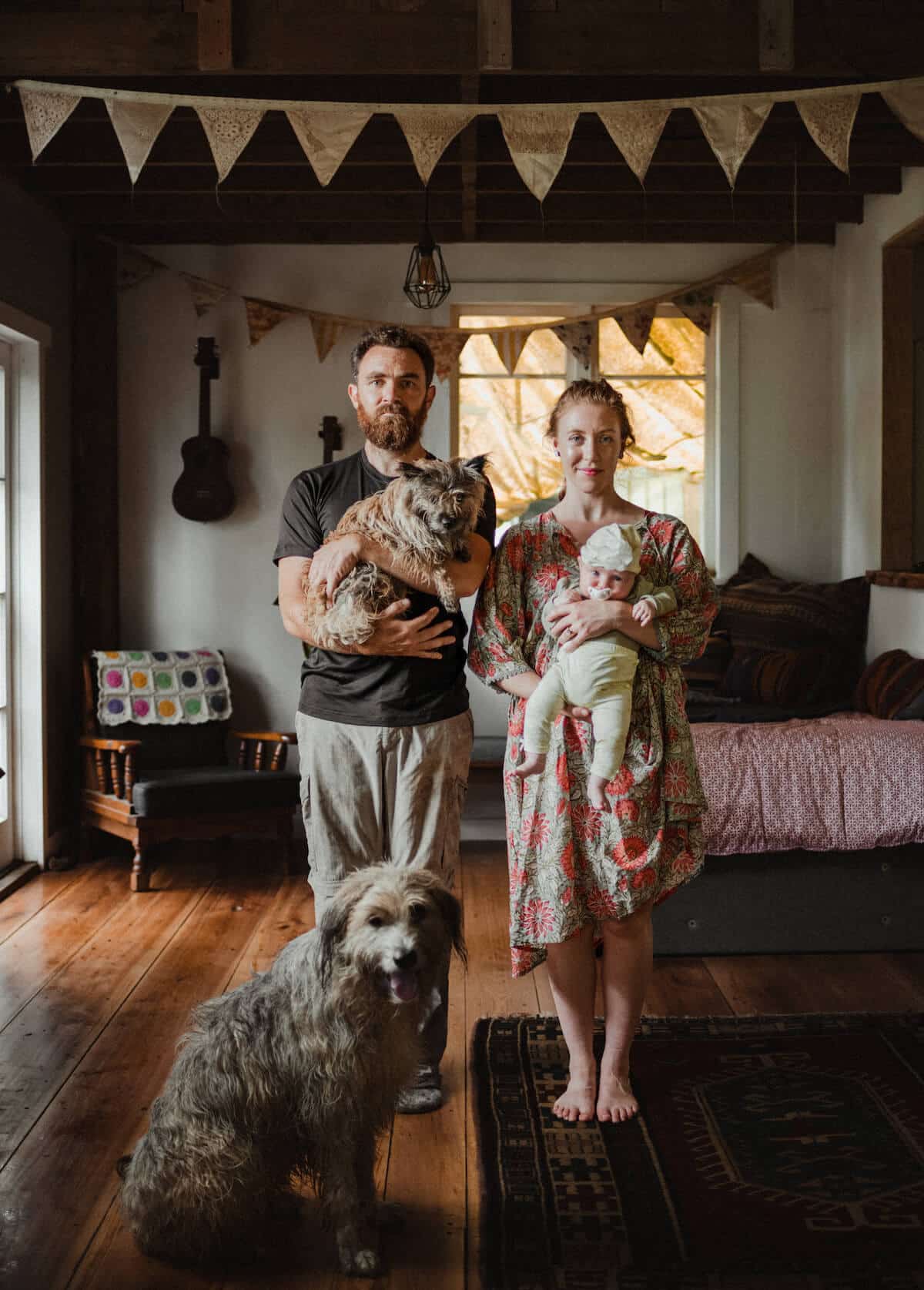 Leon holding Winne the dog and Eloise holding baby Rosamund; Margot the dog sits in front.