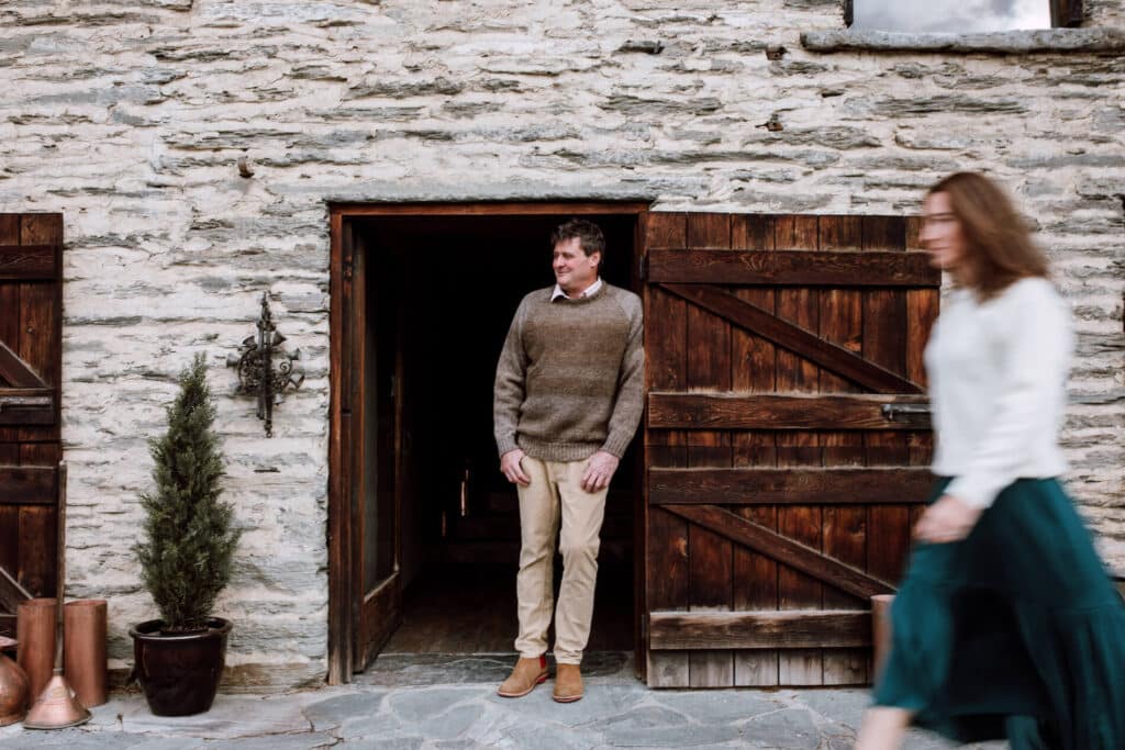 Man and woman outside old stone slate building