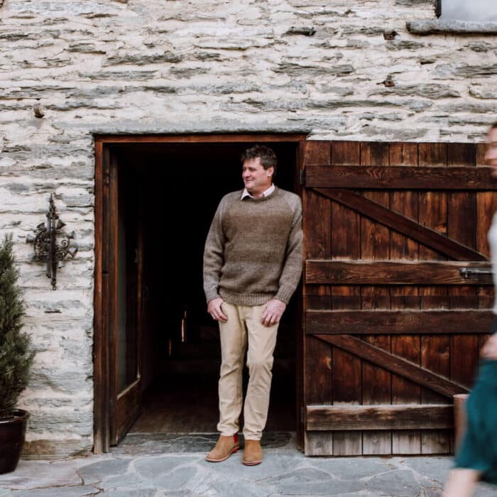 Man and woman outside old stone slate building