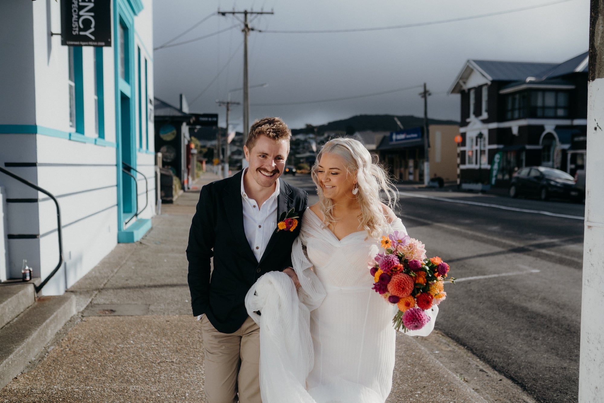 Newlywed couple walks down the main street of Aparima Riverton