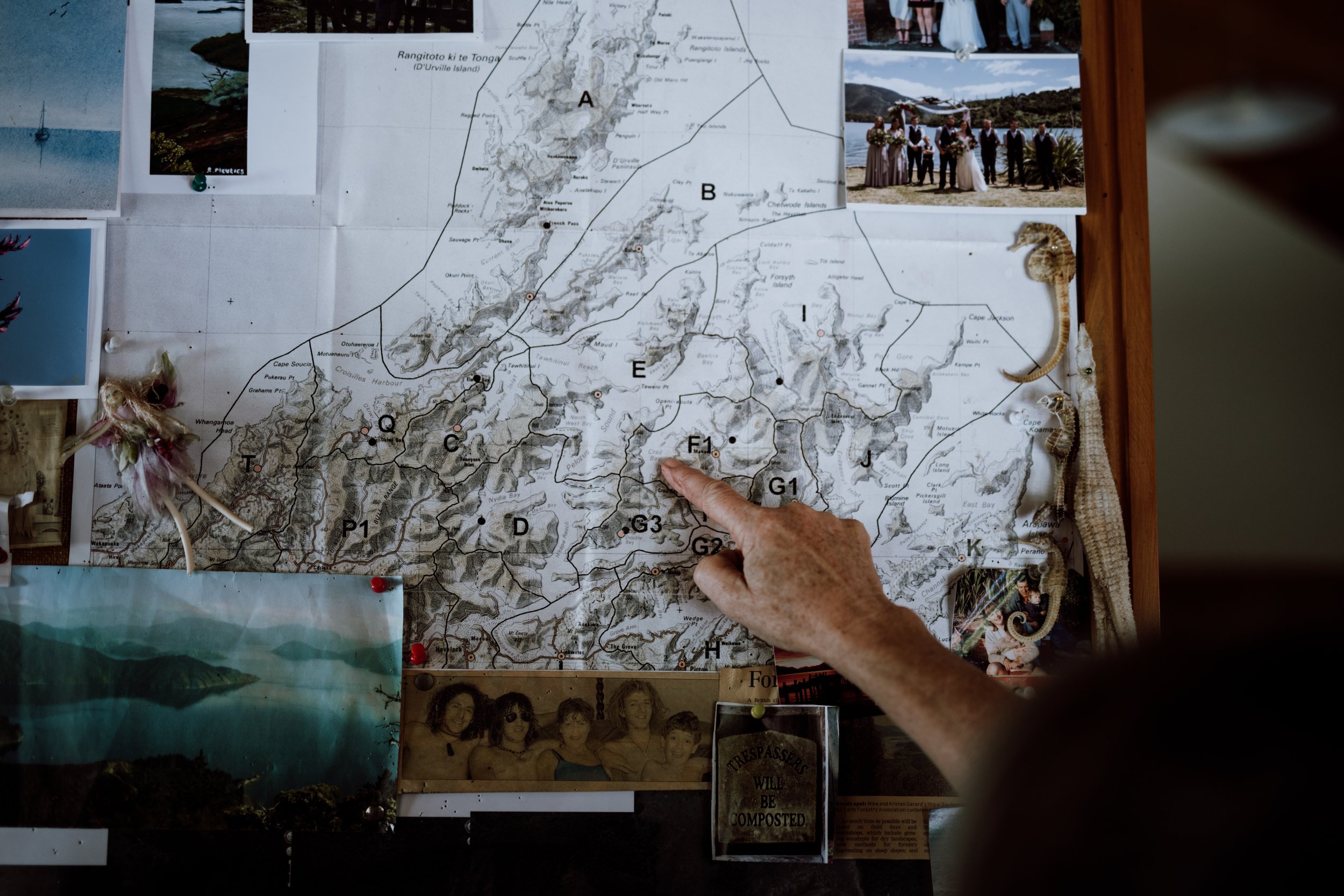 Kristen points out the home farm on a map of the Marlborough Sounds.