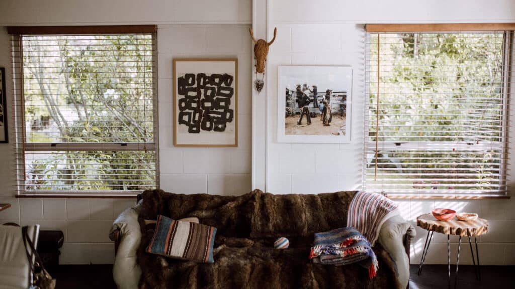 In Philippa's living room; framed print and photo on the wall, fur blanket on the couch