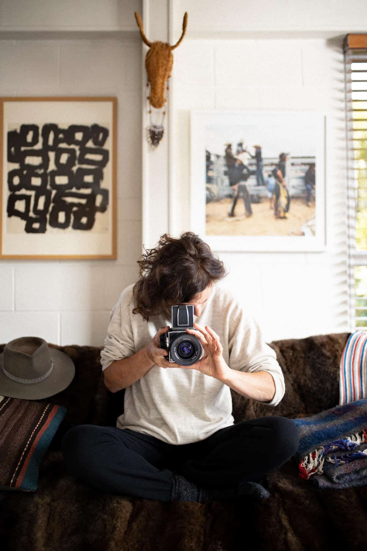 Woman looking through film camera