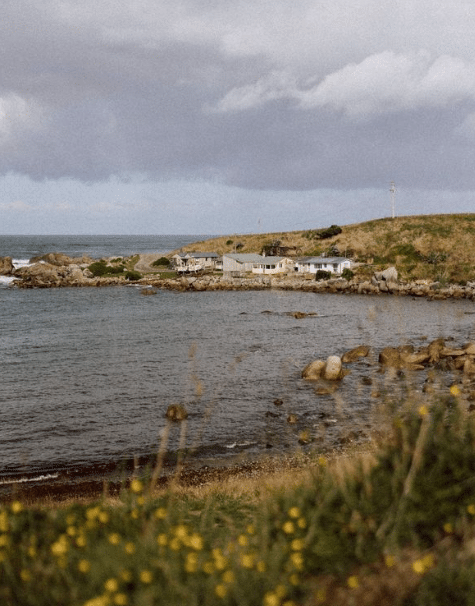Rustic, wind-weathered cribs at the shores of Mullet Bay. Crayfish, blue cod, pāua, kina and mussels are plentiful in nearby waters. Just offshore is Matariki Island, one of two small landmasses that keep the cove protected. The 1997 Ngāi Tahu Deed of Settlement returned Matariki Island and the small rocky islet to the Ngāi Tahu.