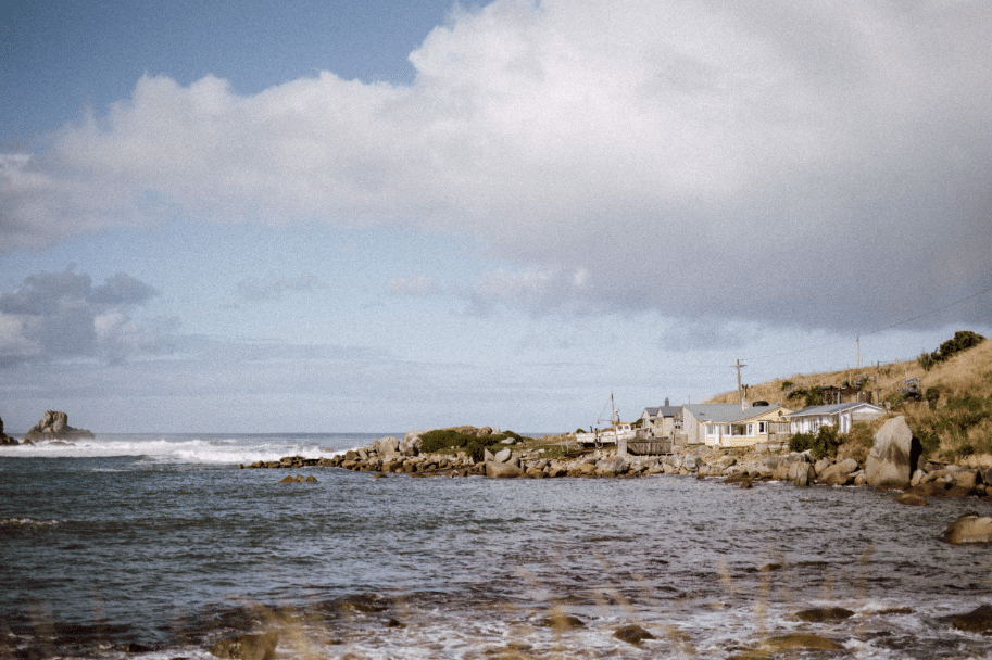 Another view of Cosy Nook. Many visitors tuck away a rock from the beach as a keepsake. To the left is the distinctive square-hewn visage of Cathedral Rock. 