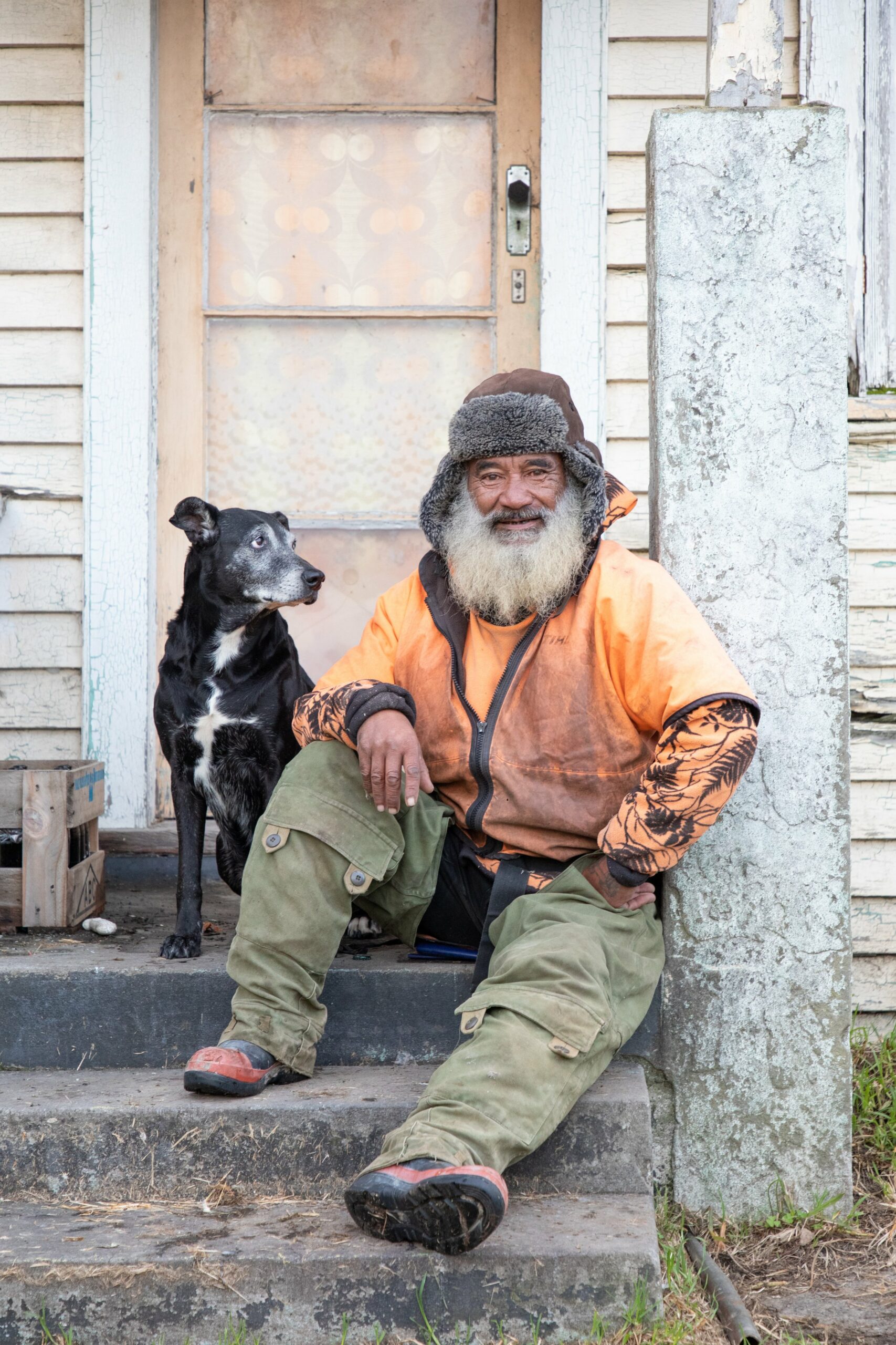 <strong>George. </strong>"This is George, and the dog is Bum-Bum. I was driving on my way to visit someone, and I spotted him sitting on his porch and went, 'I'm just going to go up and introduce myself and go - I need to photograph you.' I didn't know him. I didn't even know his name. And I've never actually done that in Te Teko. It felt slightly uncharacteristic for me to go up to someone that I hadn't met before in Te Teko and be that opportunist with a camera, I almost felt like a tourist. And then his cousin rolls on up to deliver him some food, and we knew each other. There's all these great connections. His house is like something out of a film set, it's the most incredible house. I guess this might tune into the fashion photographer that I was, but I was just pulled in by the orange vest and the khaki pants and that hat and the beard and I fell in love with him. You couldn't style a shot as well as that."