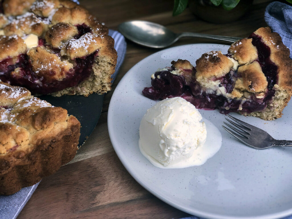 Black doris plum pie with a scoop of icecream