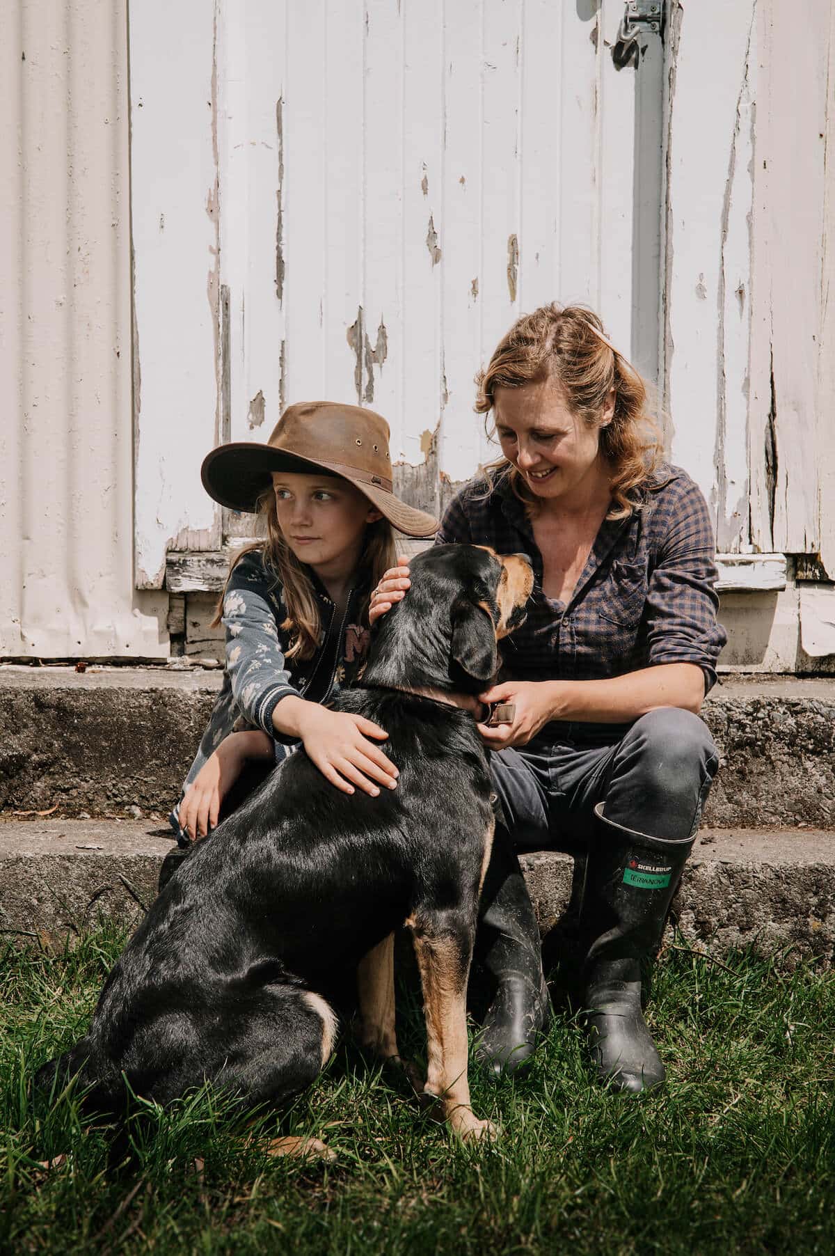 Woman and her daughter and huntaway dog