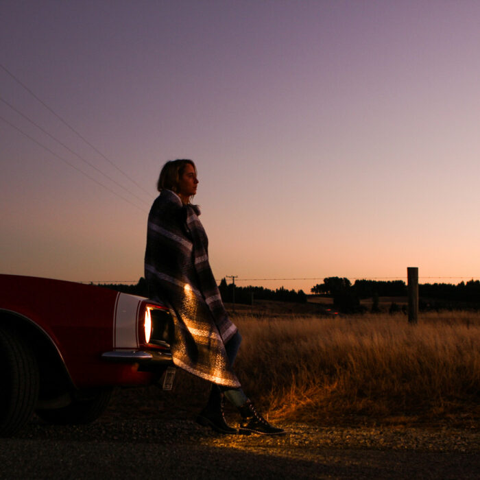 Kaylee Bell in front of a car