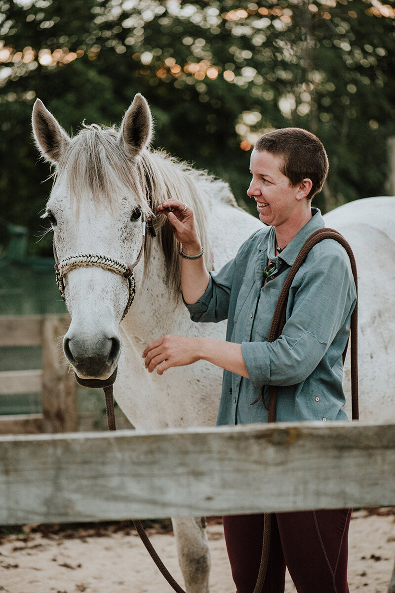 Larissa stroking her horse