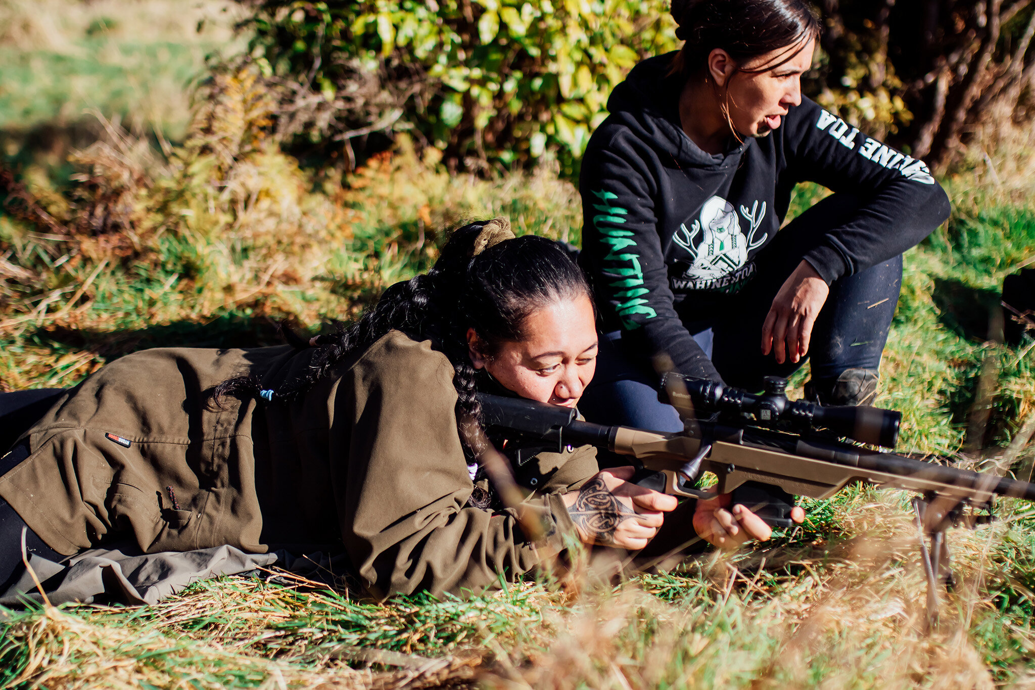 Women on the ground with a gun
