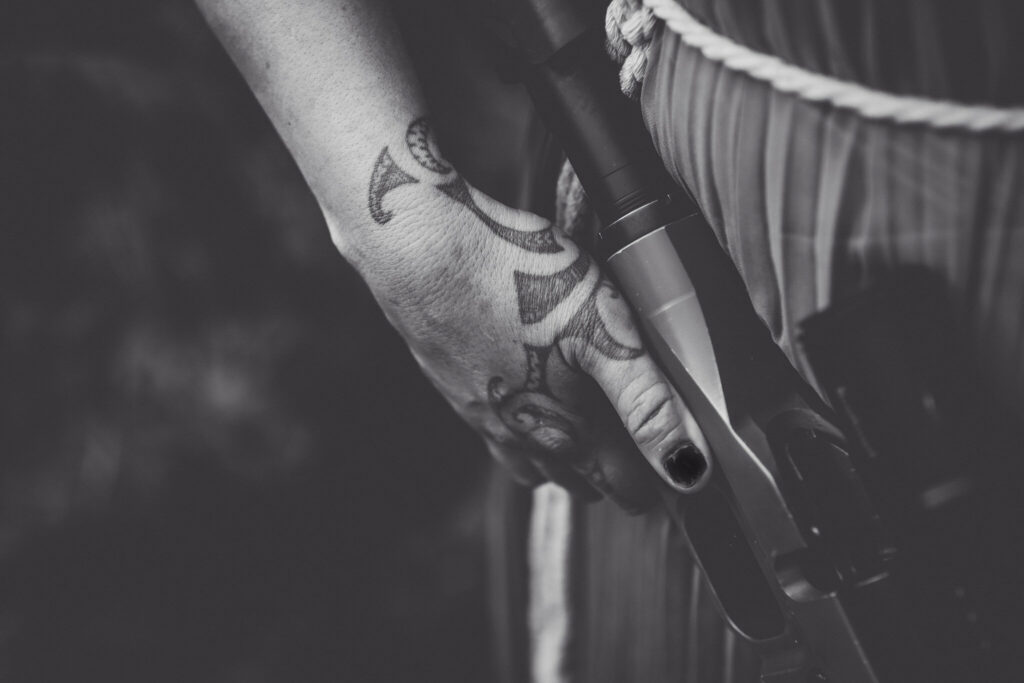 Pania Marsh's hand holding a gun