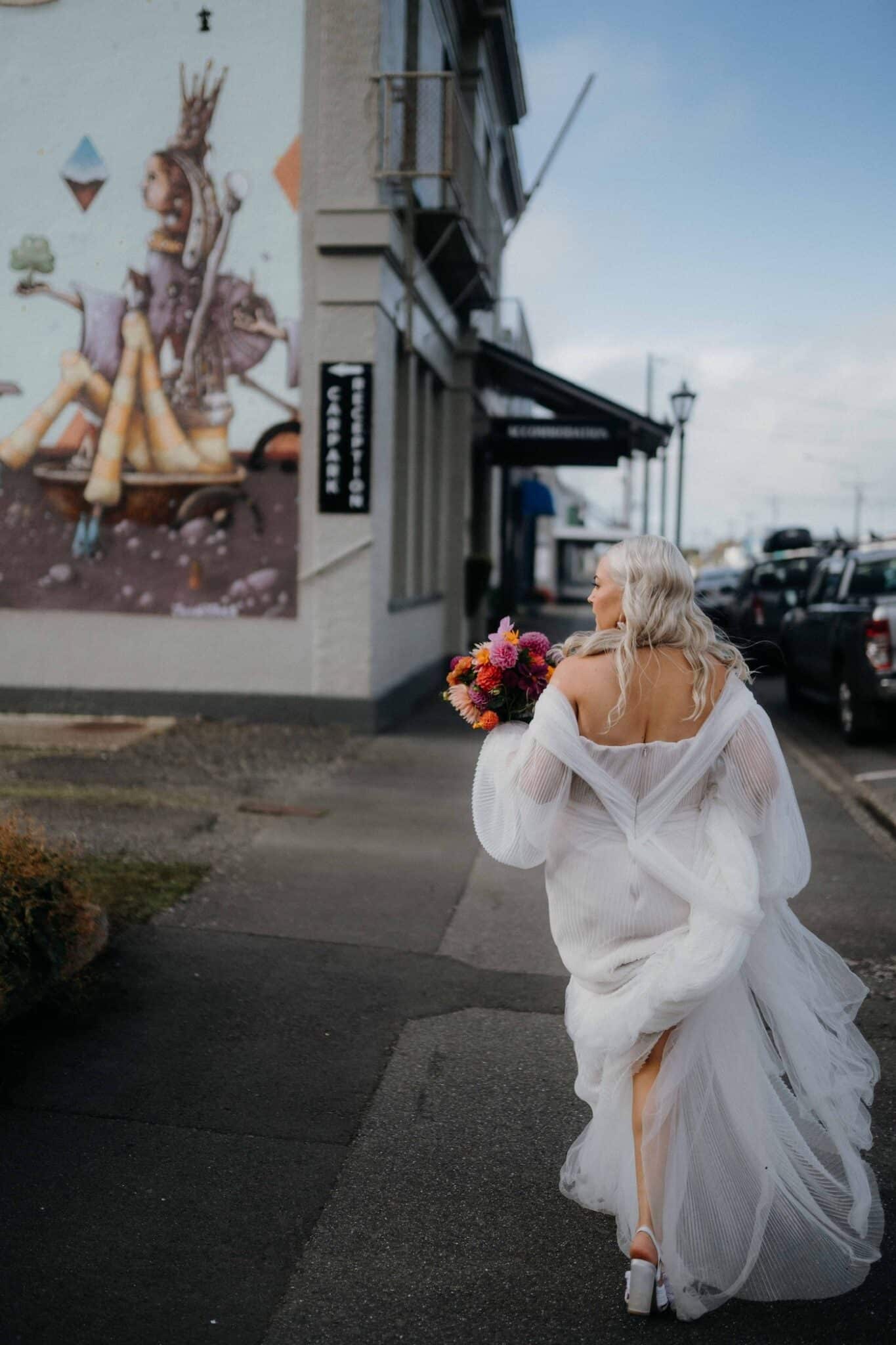 A bride walks down the main street in Aparima Riverton
