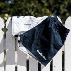 A pair of shorts hang on a fence