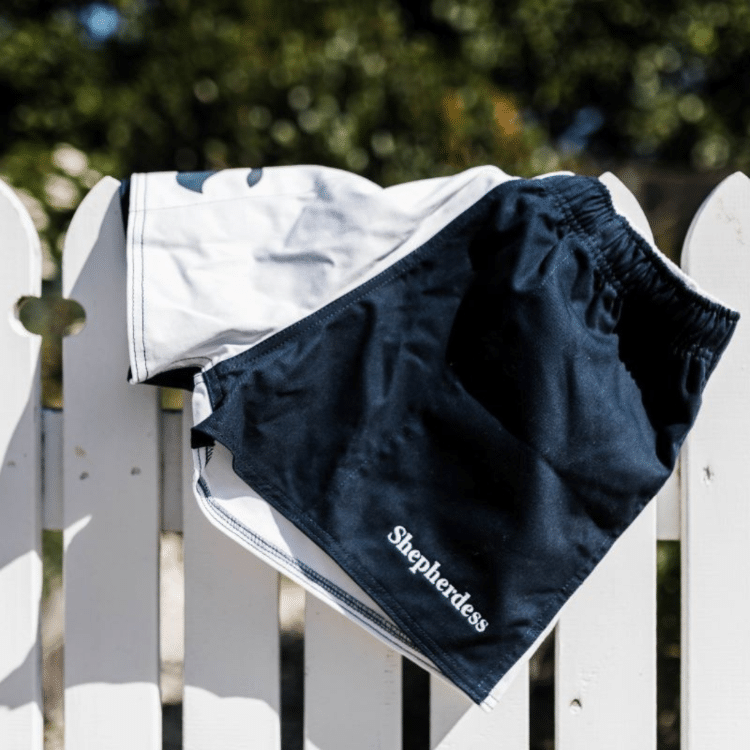 A pair of shorts hang on a fence