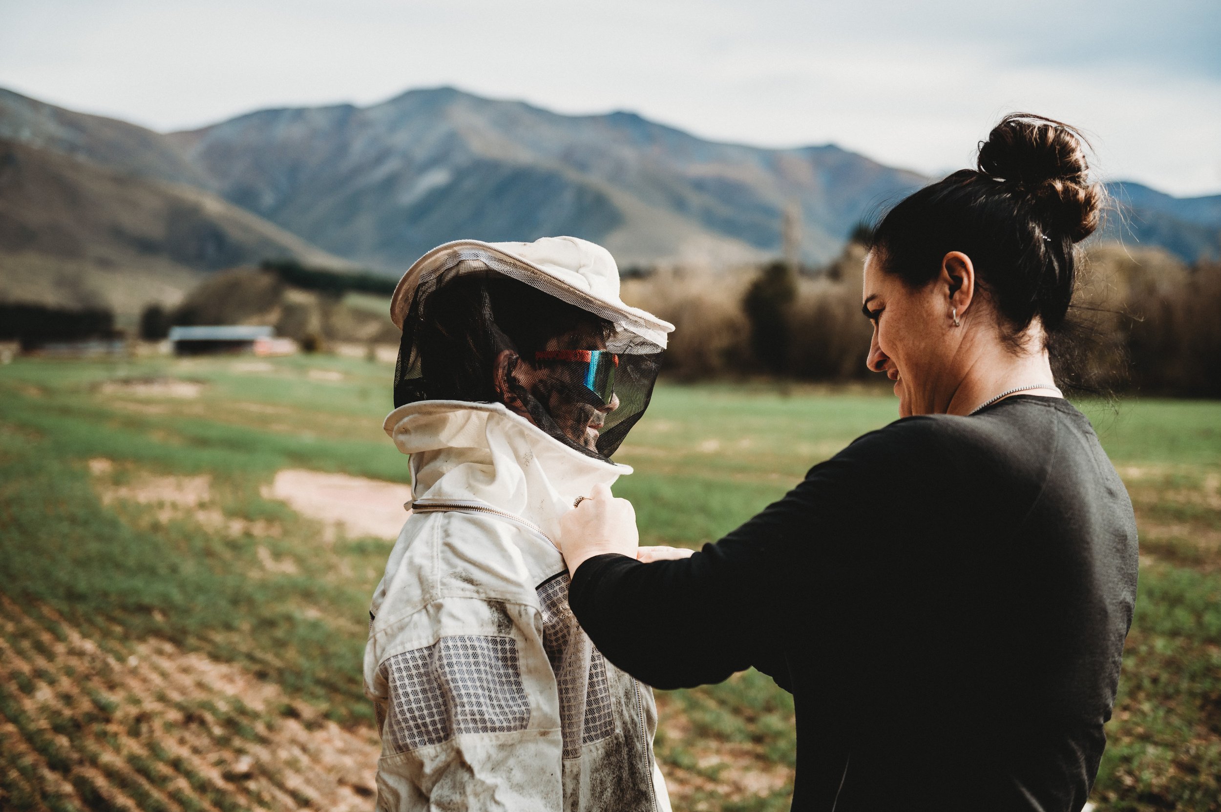 Juliet helping Ben with his bee suit.