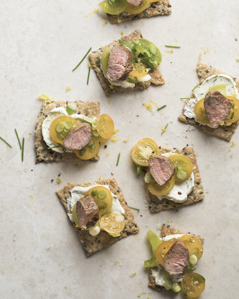Lamb and tomatos on crackers