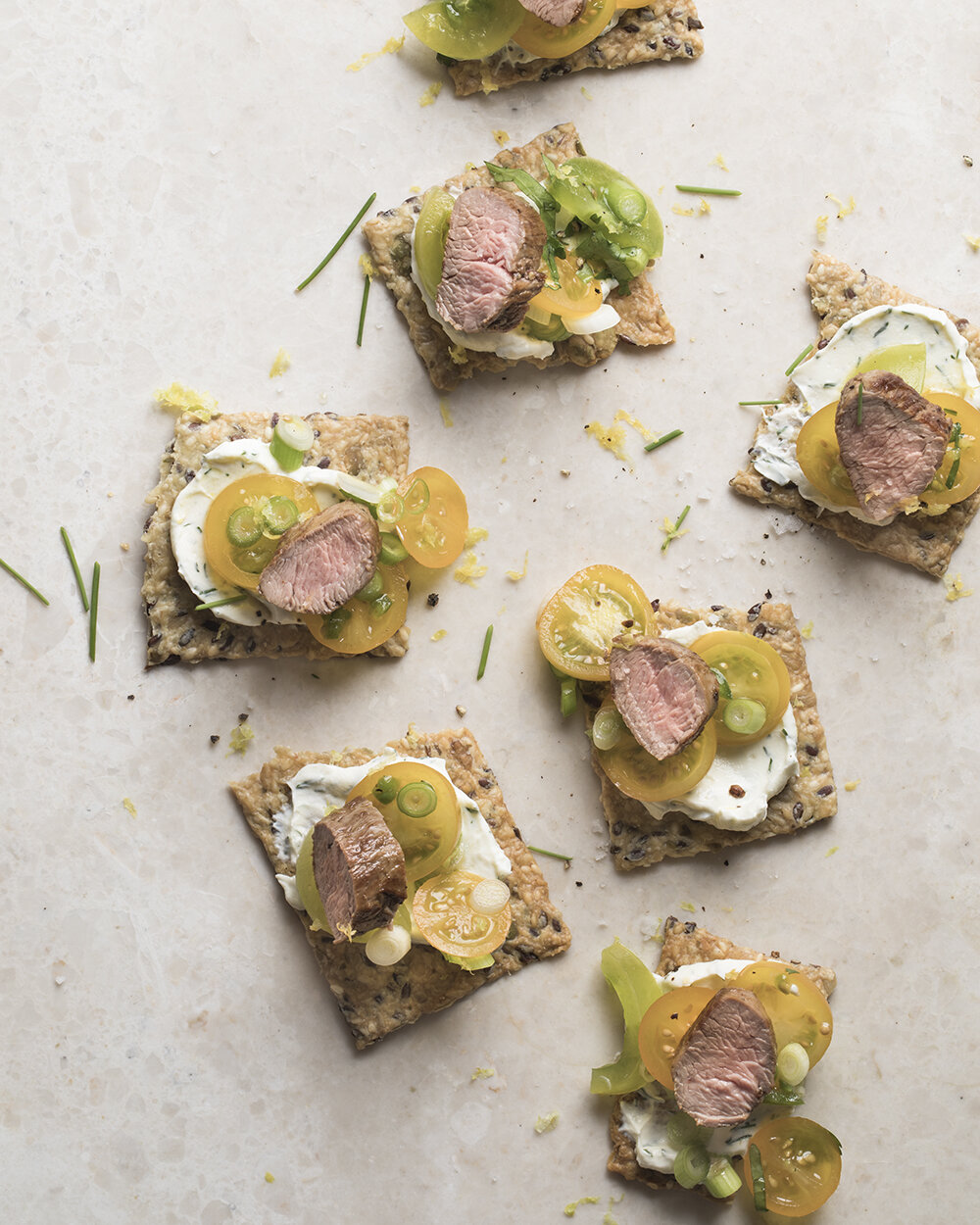 Lamb and tomatos on crackers