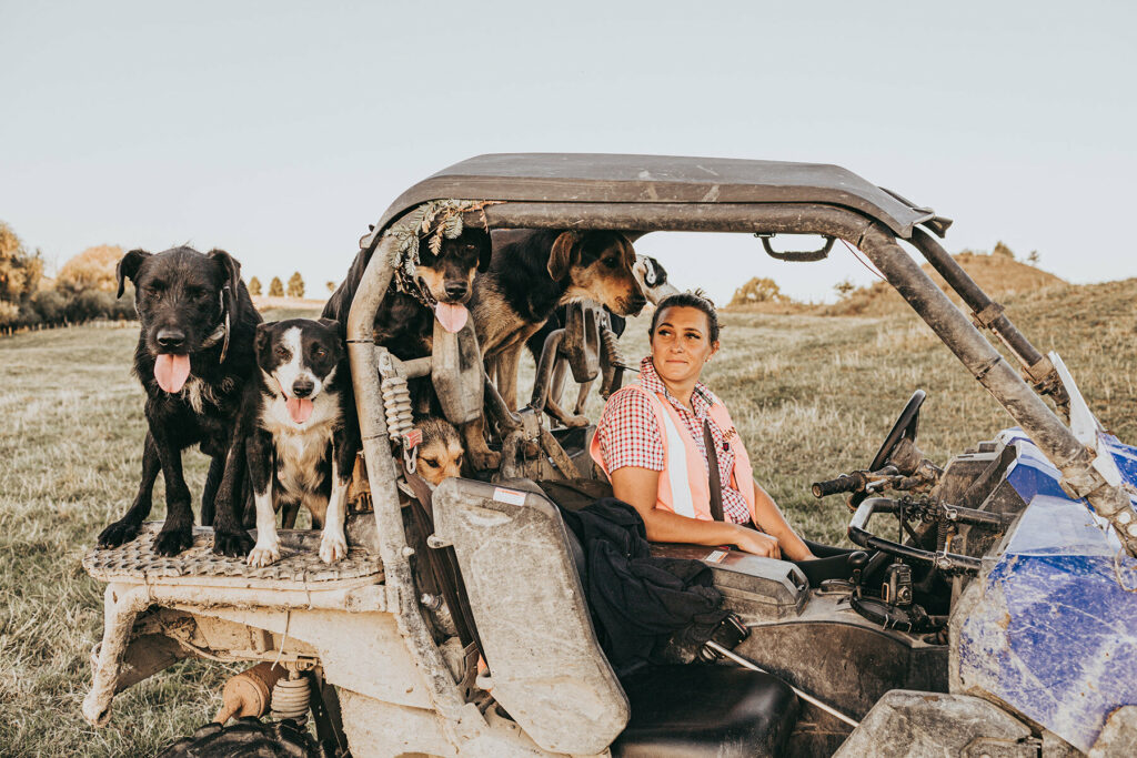 Anita Kendrick in a tractor with dogs