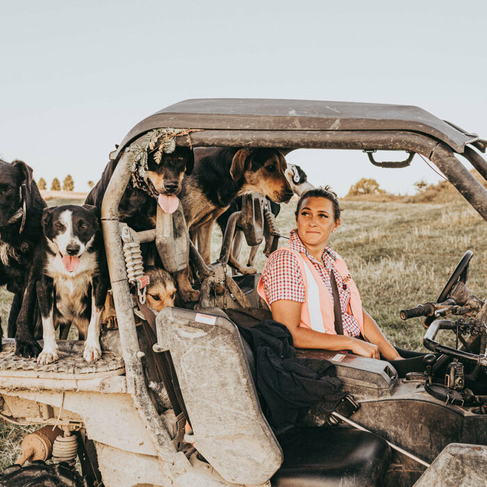 Anita Kendrick in a tractor with dogs