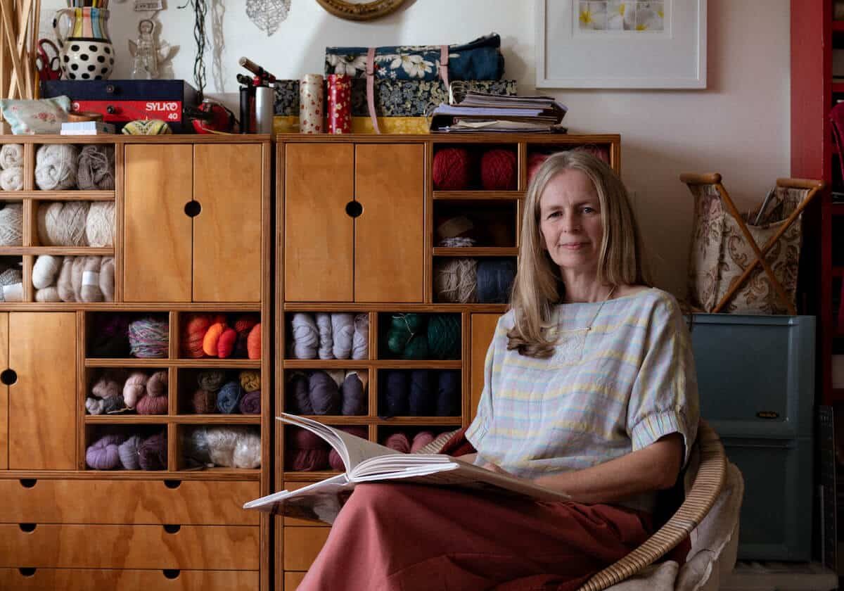 Woman sits in her studio