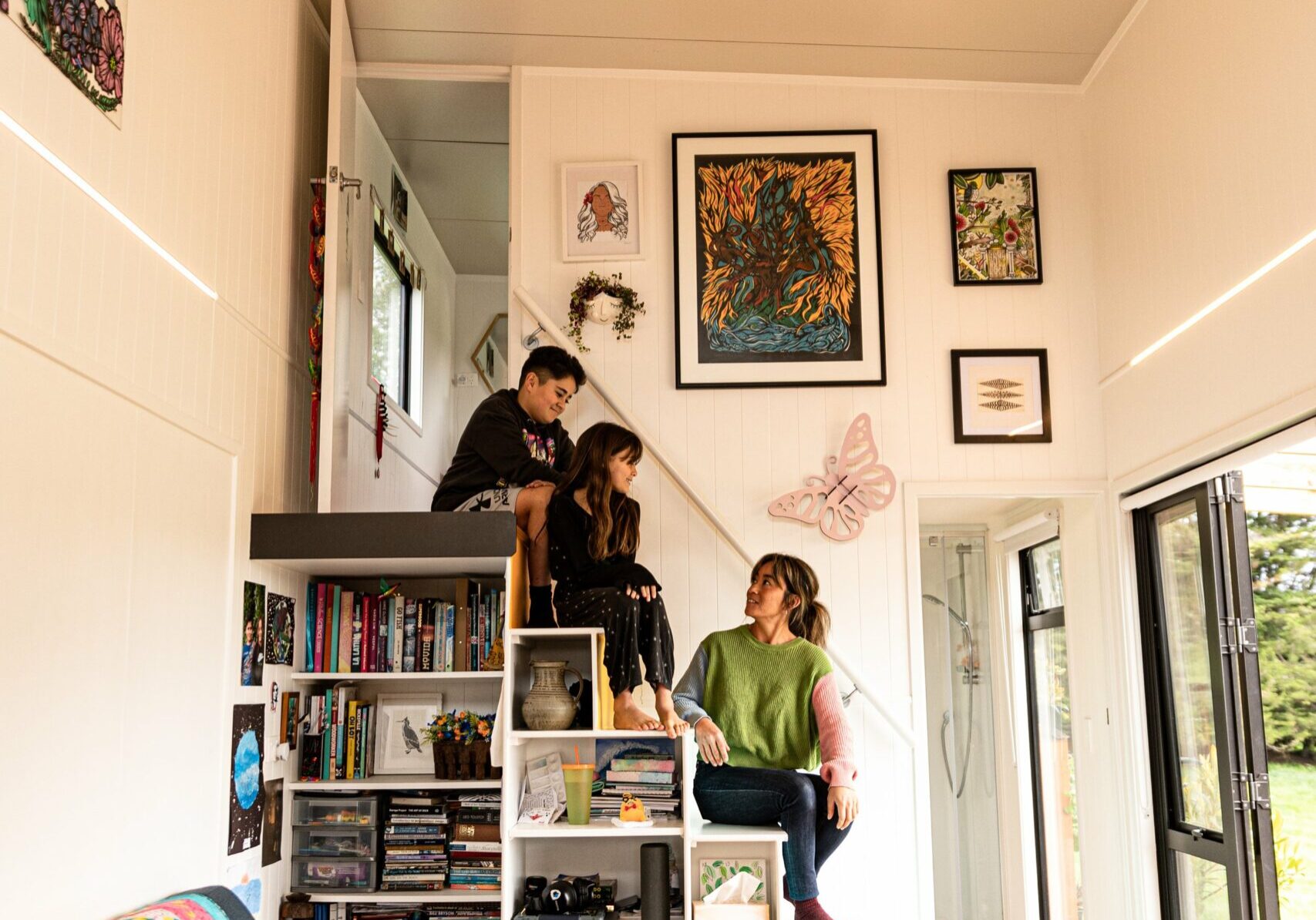 Sina and her kids sit on the stairs