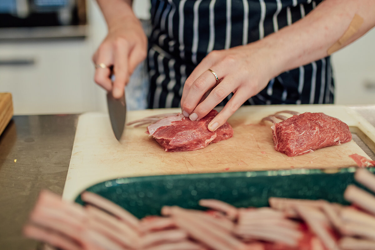 Person chopping up meat
