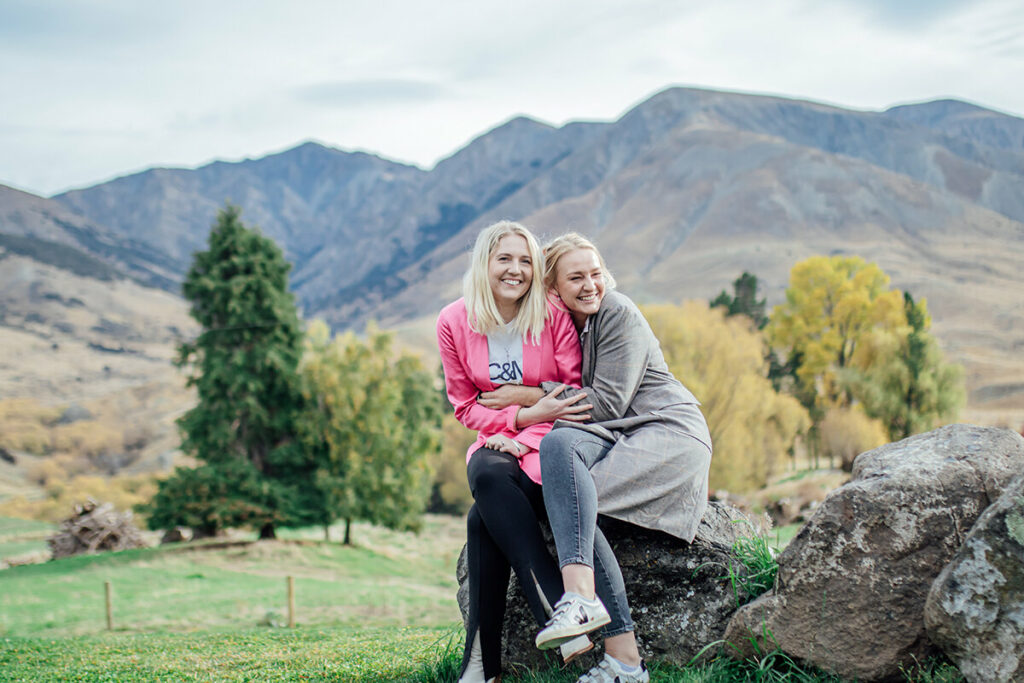 Sophie and Lucy hugging on a rock