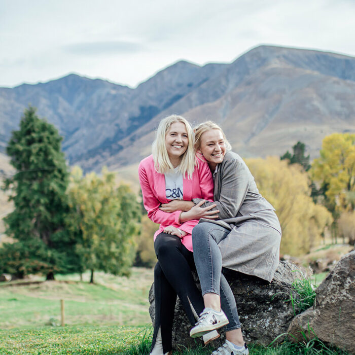 Sophie and Lucy hugging on a rock