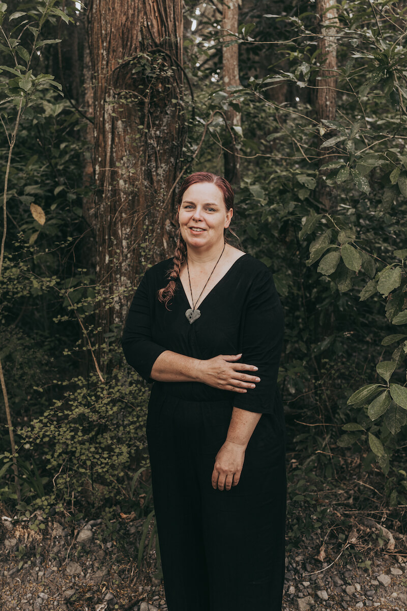Woman in front of trees