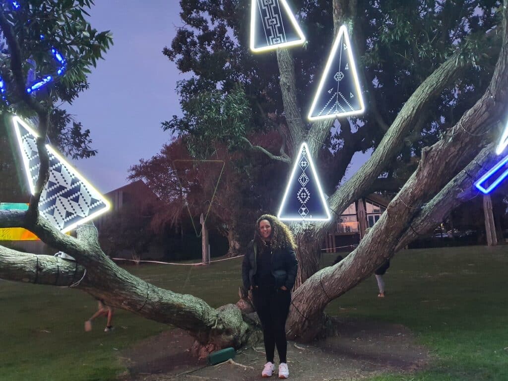 Woman in front of artwork in tree