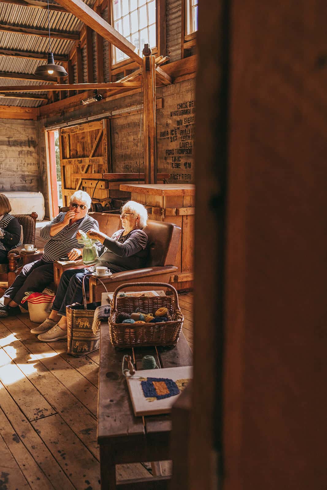 Women in a woolshed, chatting