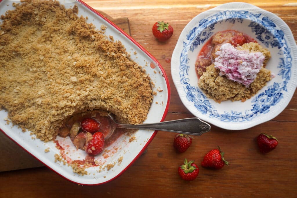 Rhubarb and berry crumble served in an enamel dish.