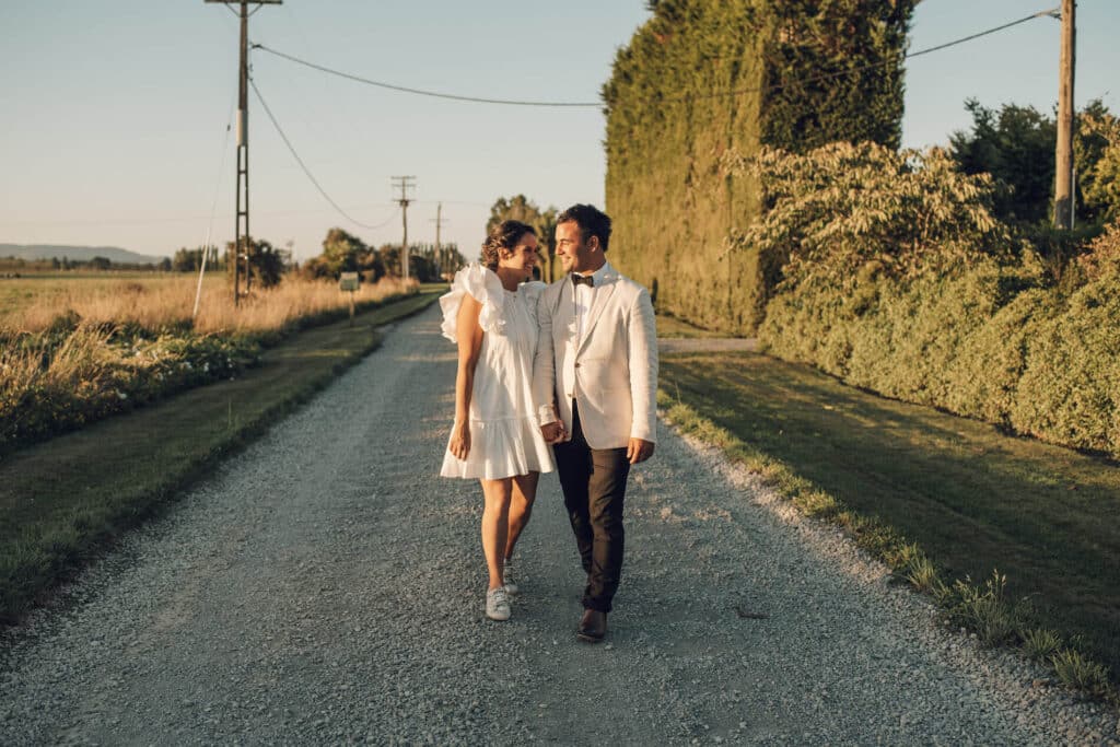 Newly married walk down a country road